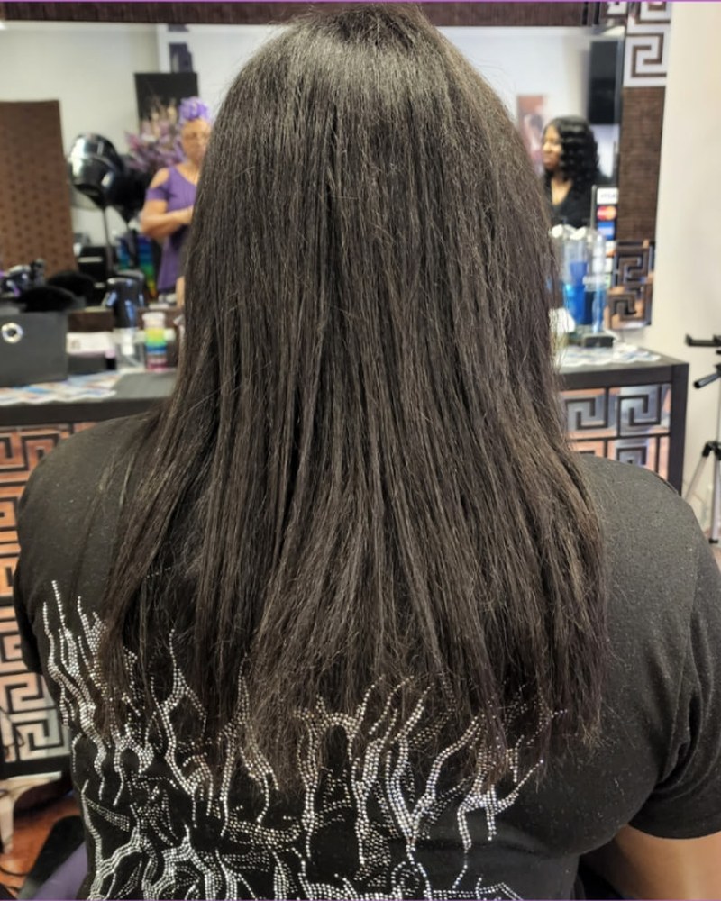 Dark shoulder-length hair before hand-tied extensions