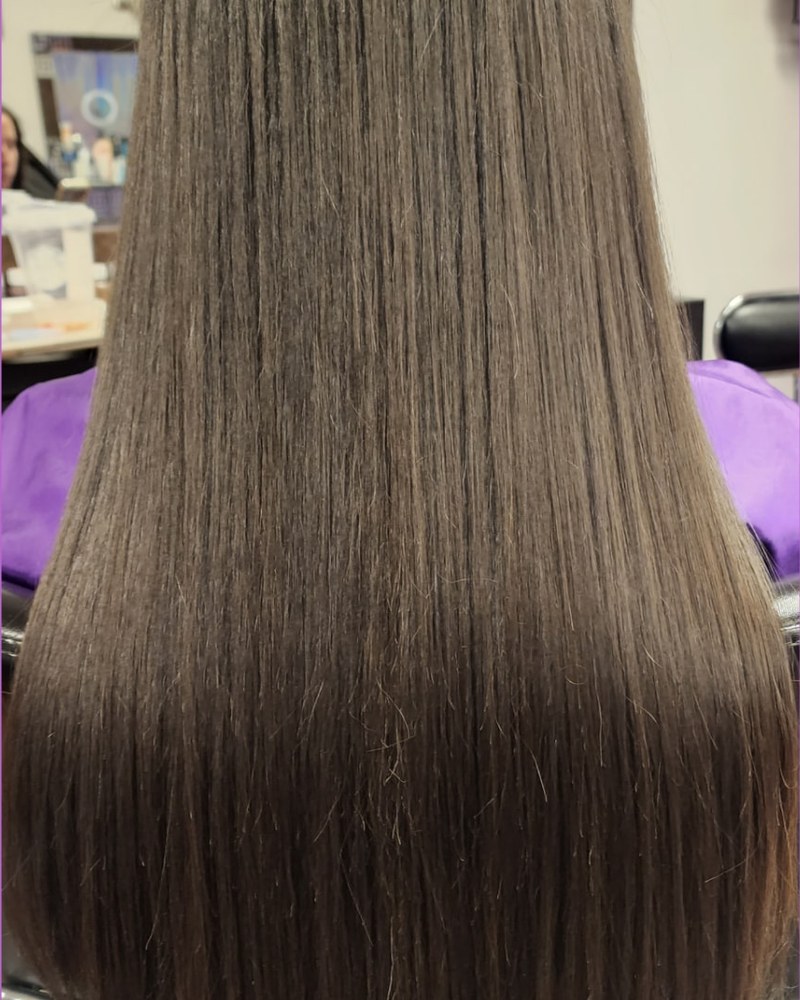 Long dark hair after hand-tied extensions